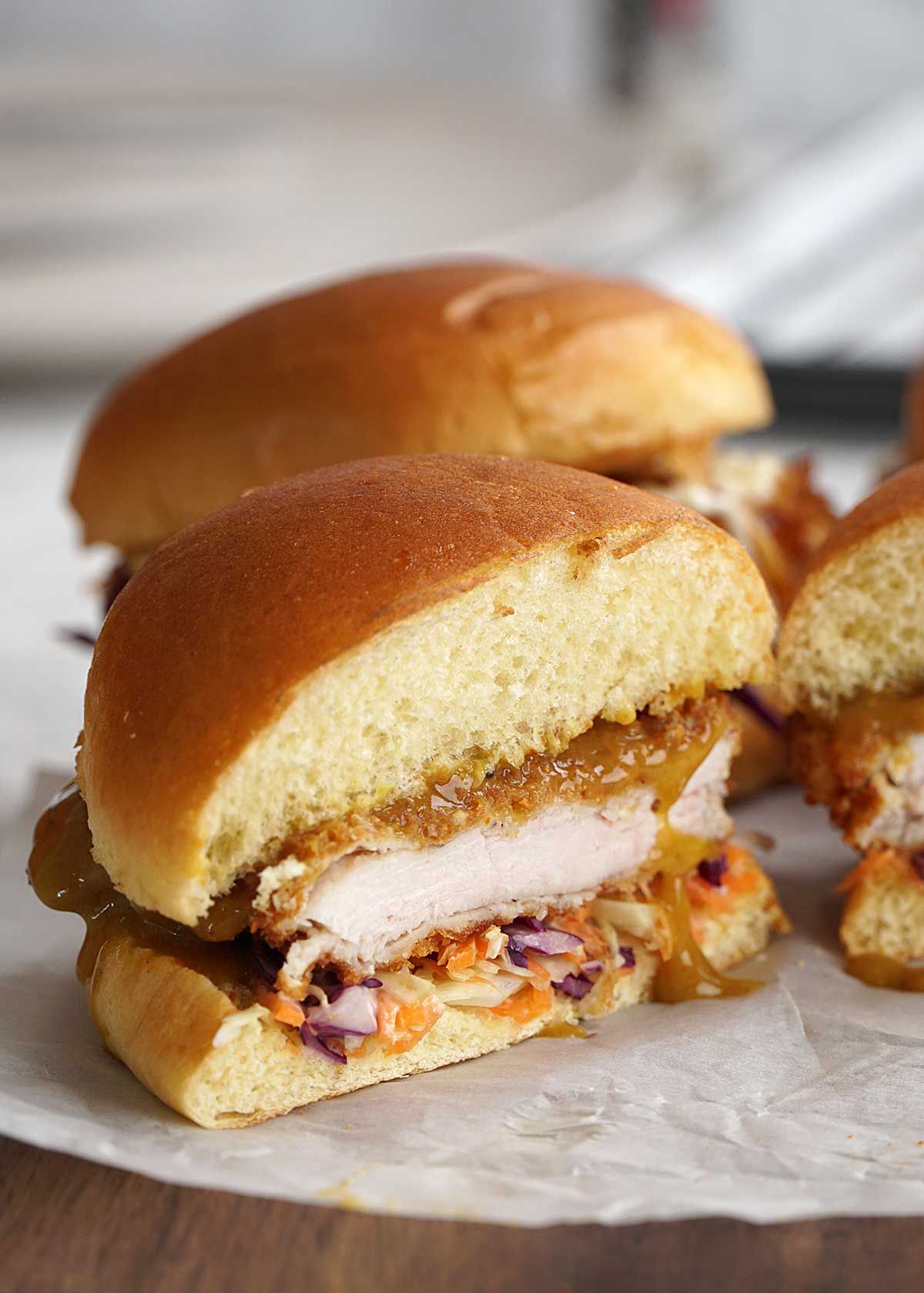 japanese chicken burger cut in half and align together with other burger.