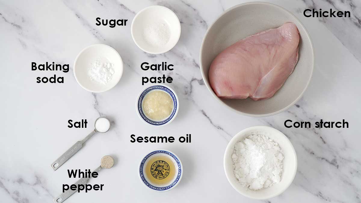 Labelled ingredients for chicken balls on the white table.