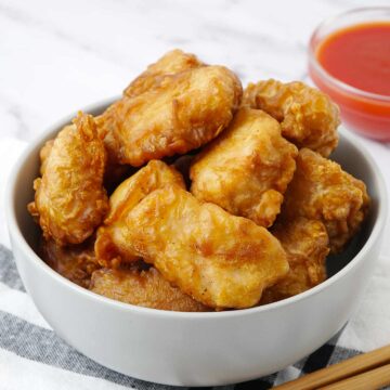 A grey bowl containing deep fried chicken balls.