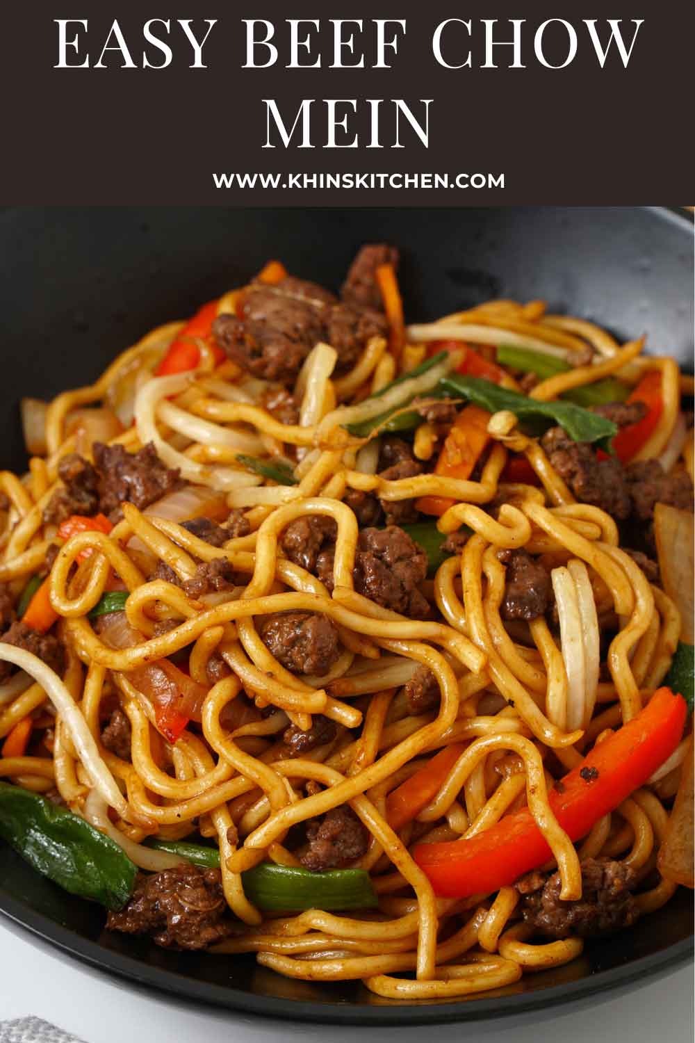 A black bowl containing stir fry noodles, ground beef and vegetables.