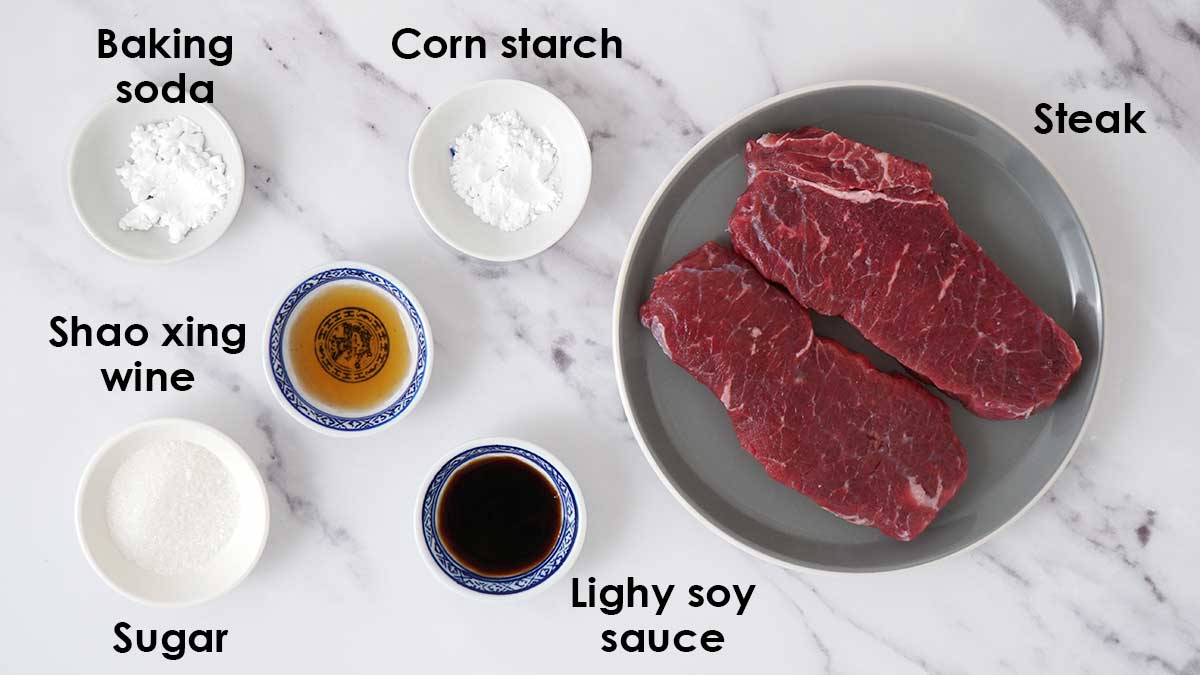 Labelled ingredients for beef marinade display on the white table. 