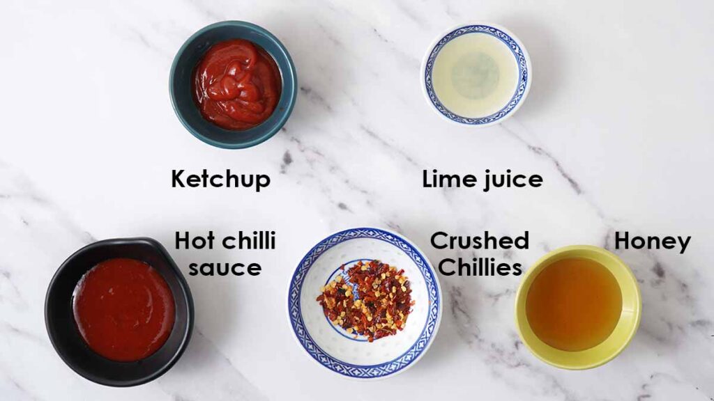 Labelled chilli sauce ingredients, displayed on the white table. 