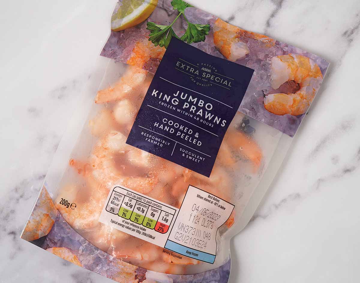 A frozen jumbo king prawns packet displayed on the white table. 