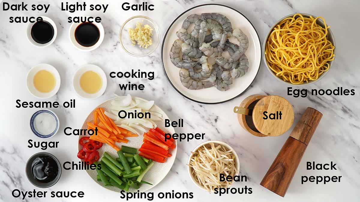 Labelled ingredients of prawn chow mien, displayed on the white table. 