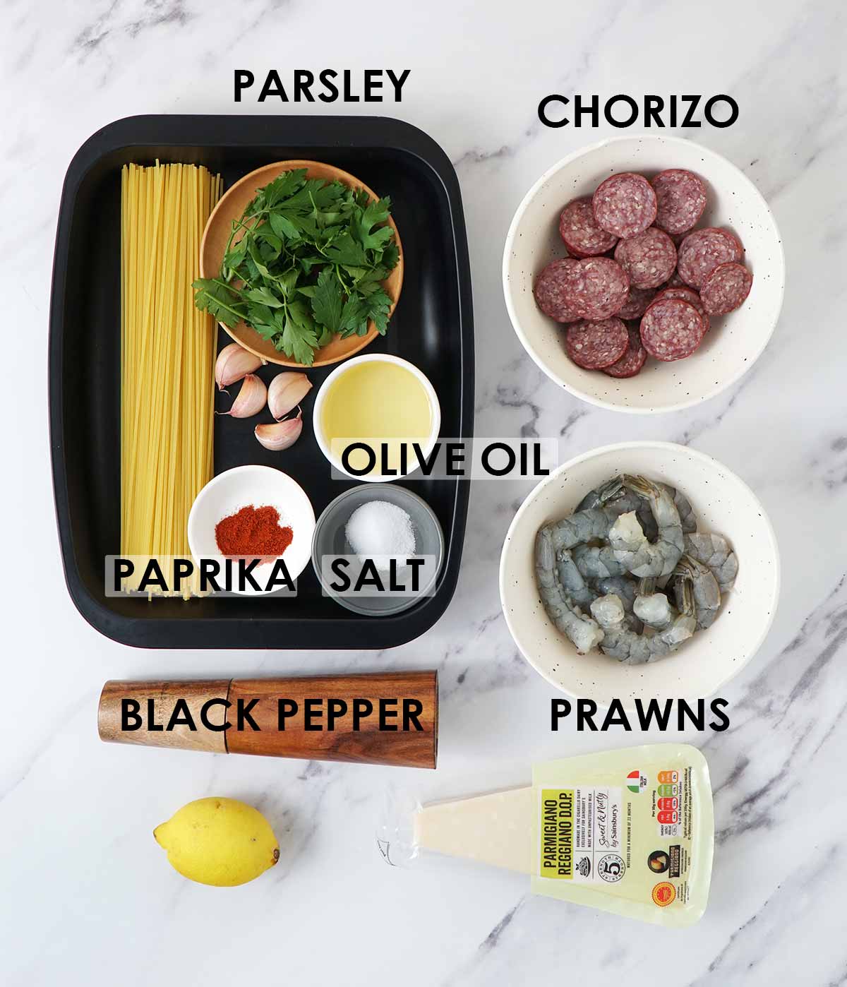Labelled prawn pasta ingredients displayed on the white table. 