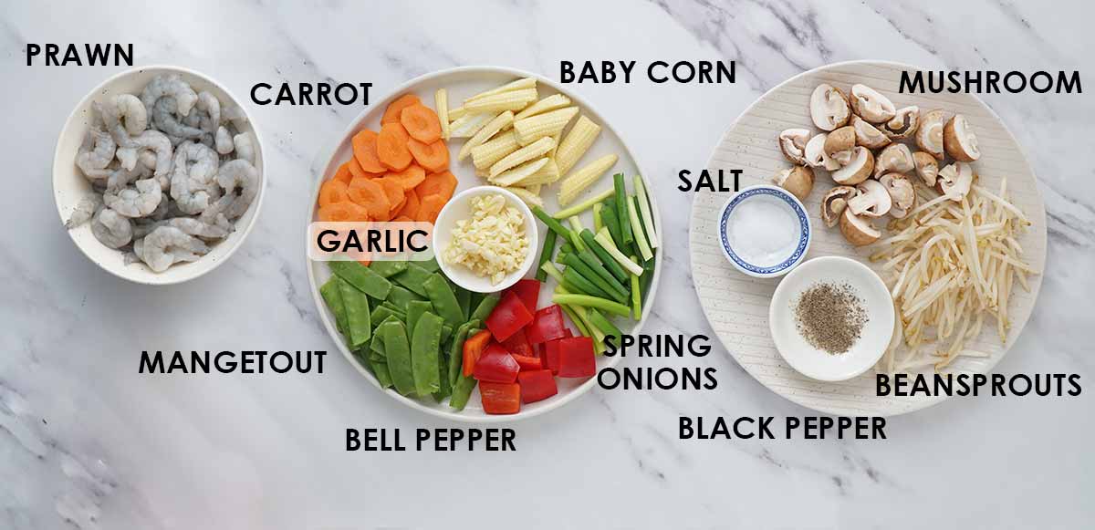 Labelled stir fry ingredients, displayed on the white table. 