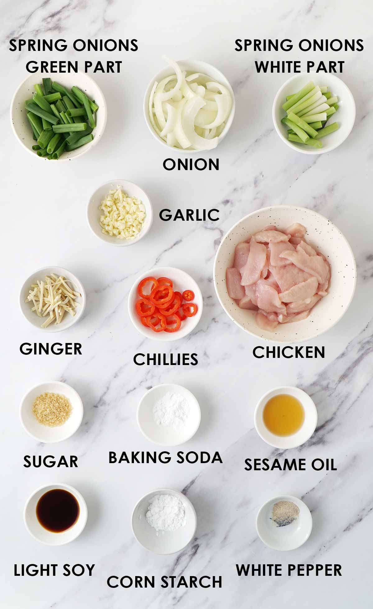 Labelled ginger chicken ingredients displayed on the white table.  