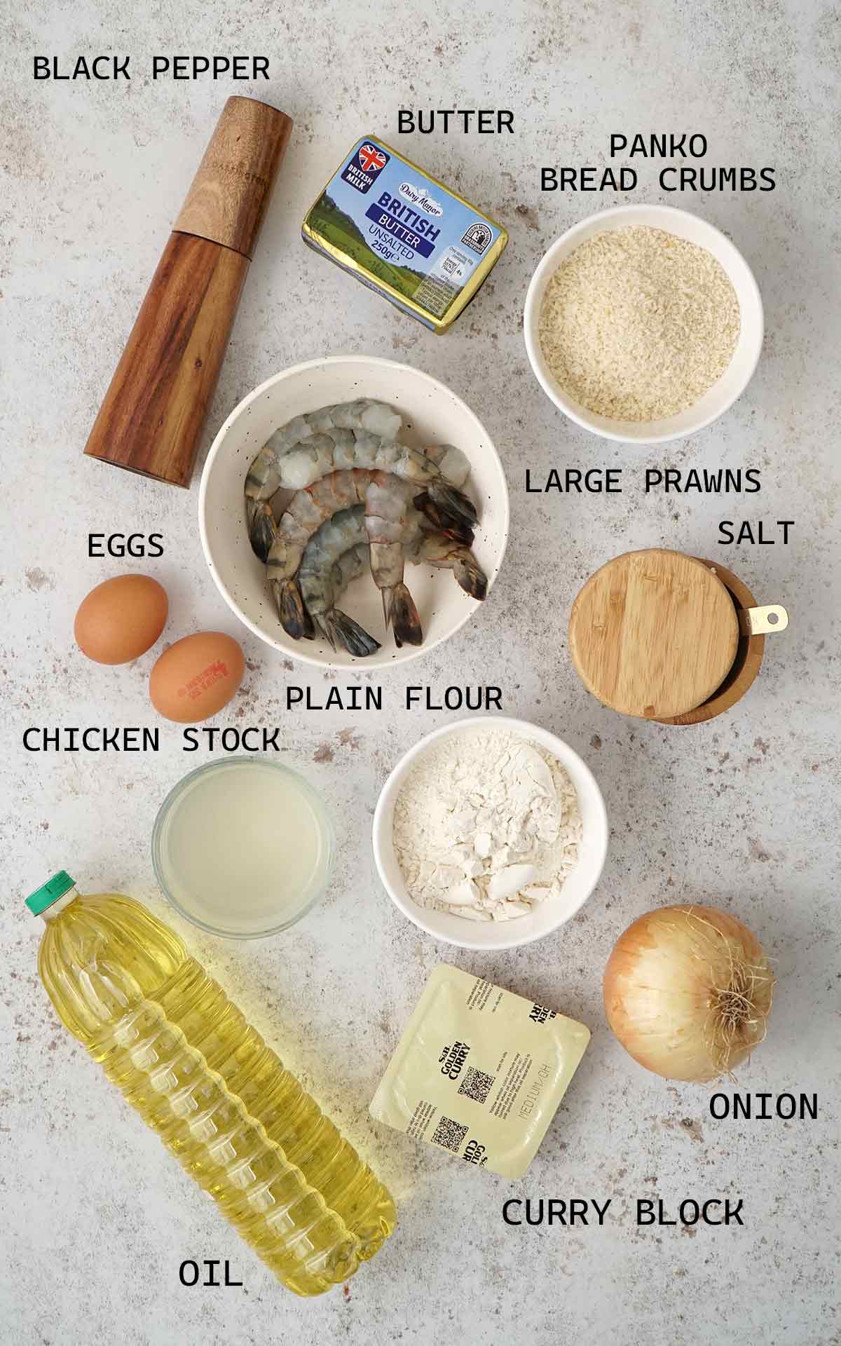 Labelled ingredients of making prawn katsu curry displayed on the white table.