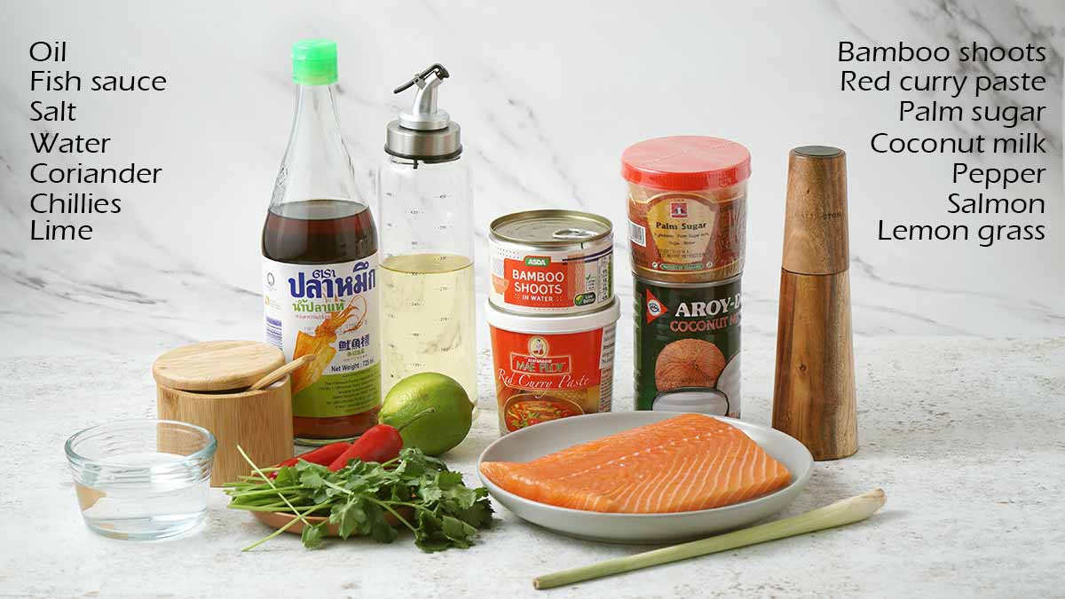 Labelled ingredients of making salmon curry displayed on the white table. 