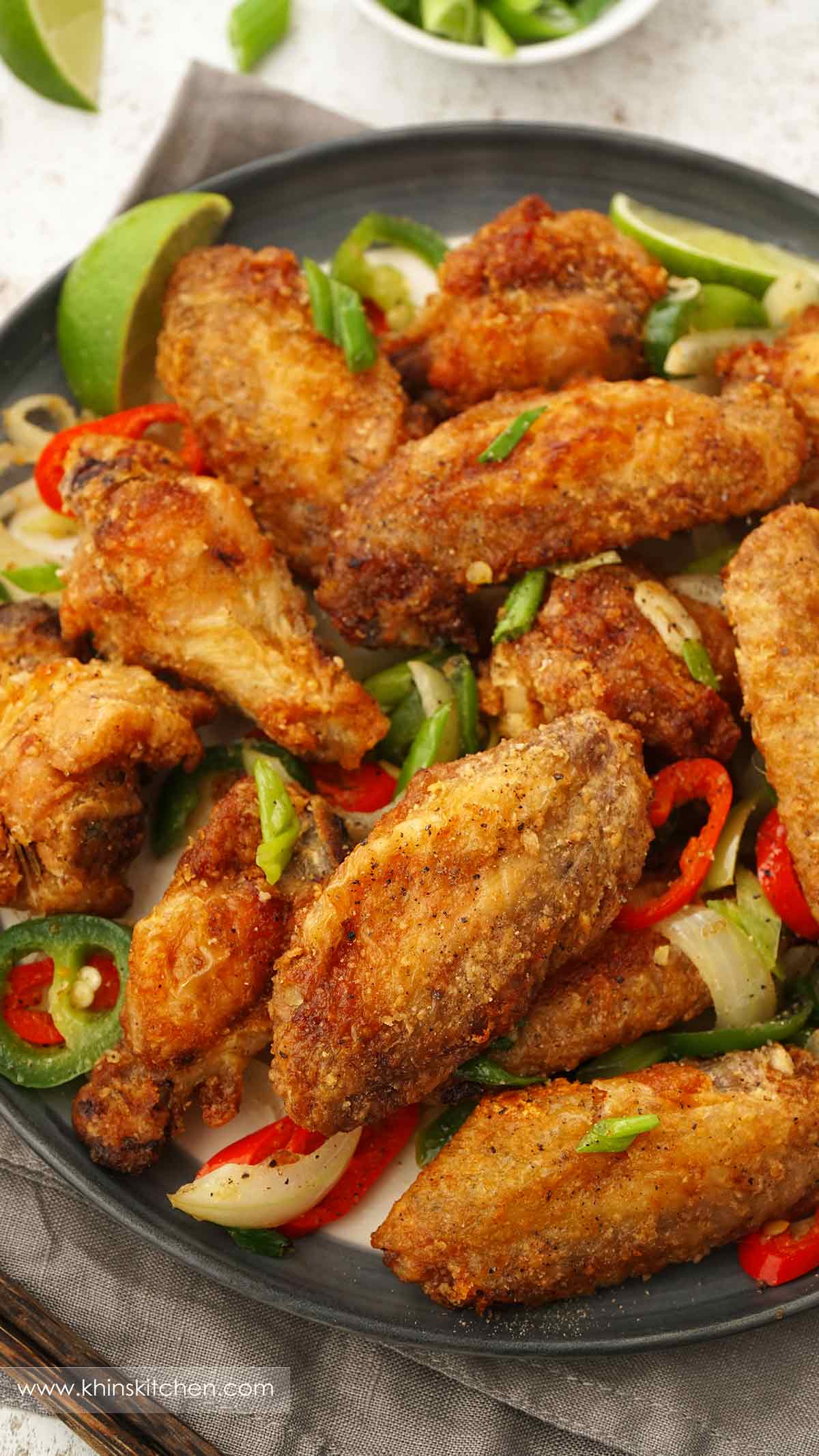 Chinese style crispy fried golden chicken wings with onions, spring onions, chilli slices and salt and pepper seasonings. 