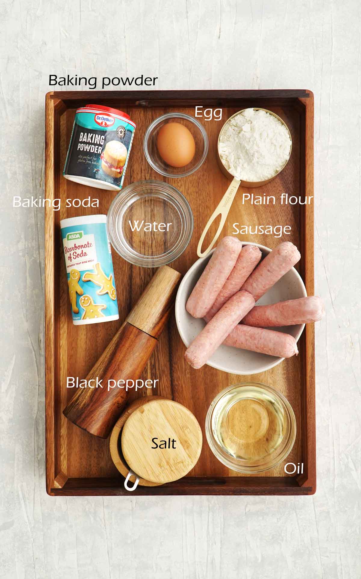 Labelled ingredients displayed on the wooden tray. 