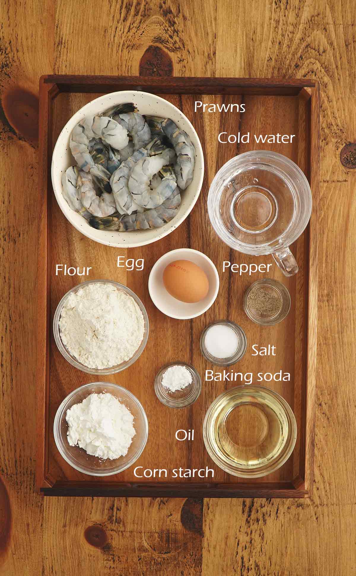 Labelled ingredients displayed on the wooden table. 
