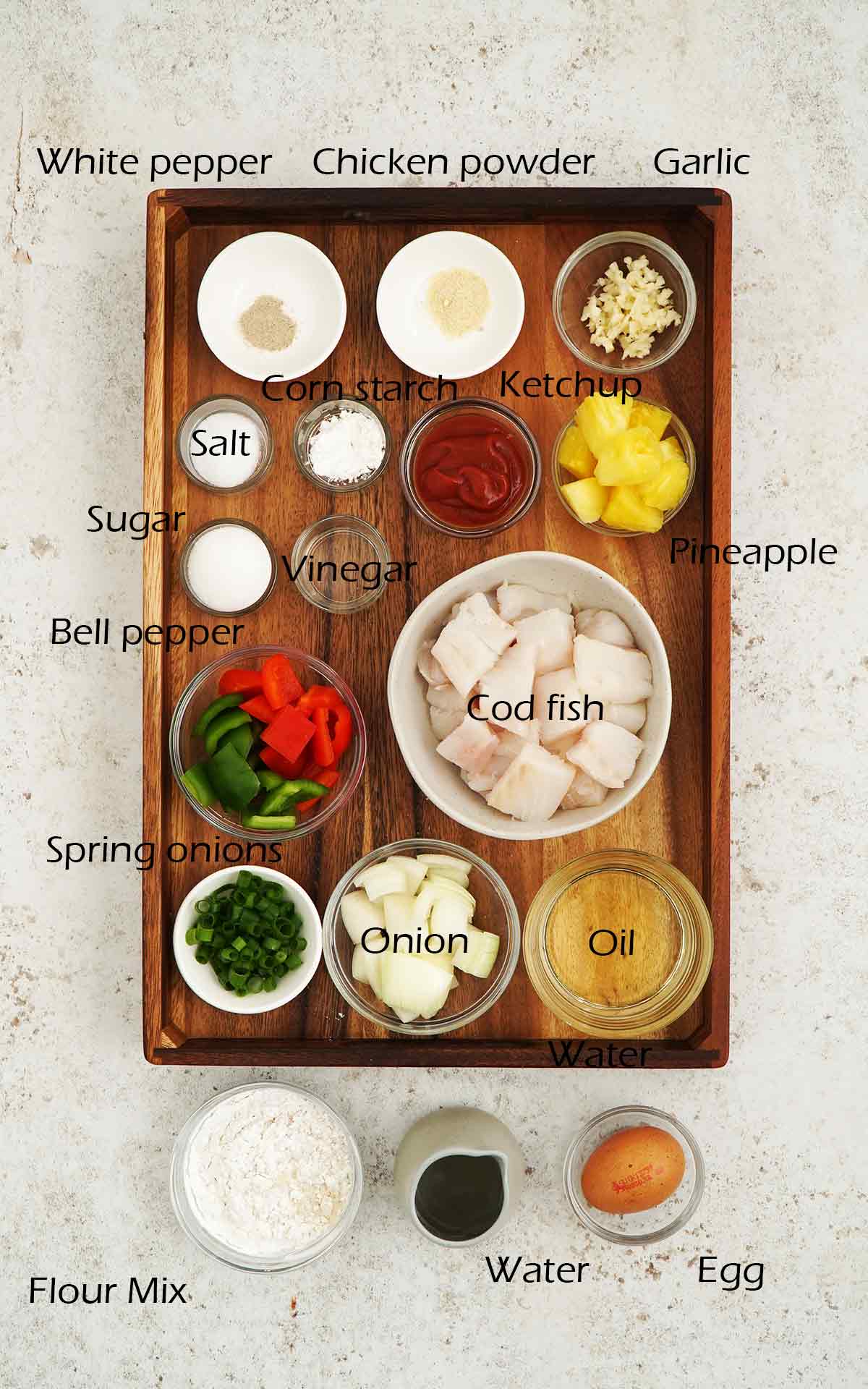 Labelled ingredients displayed on the wooden tray.
