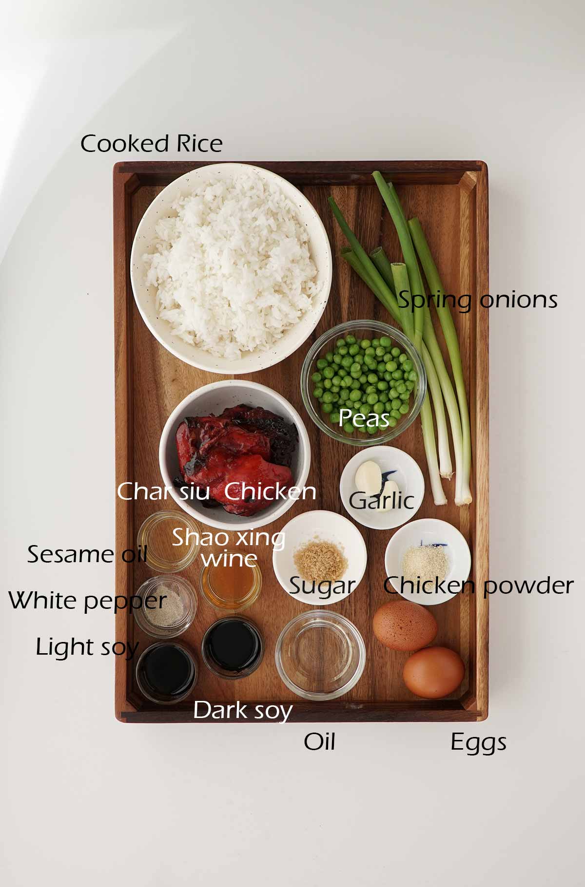 Labelled ingredients displayed on the wooden tray. 