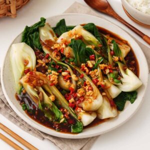 A plate containing Chinese garlic pak choi with delicious sauce.