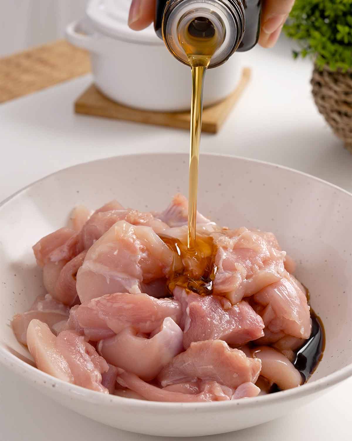 An image showing how to prepare chicken marinade in a white bowl.