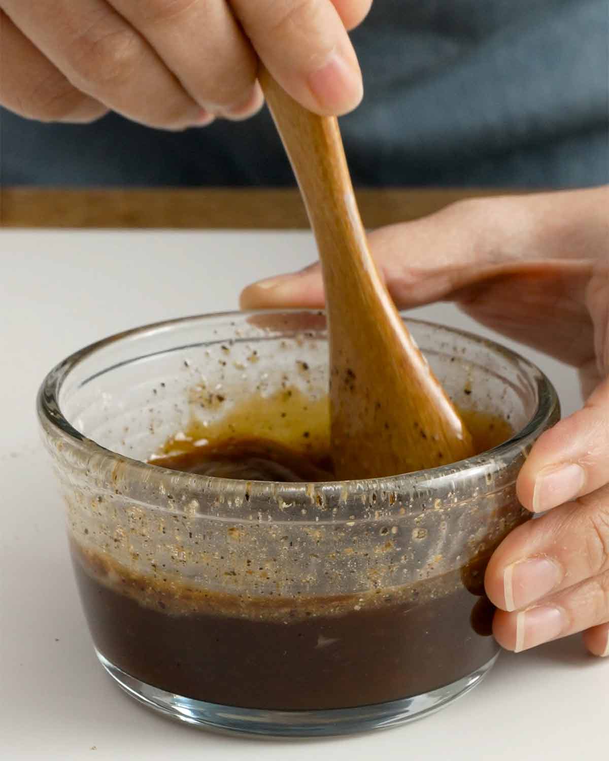 An image showing how to prepare black pepper sauce ingredients in a small bowl.