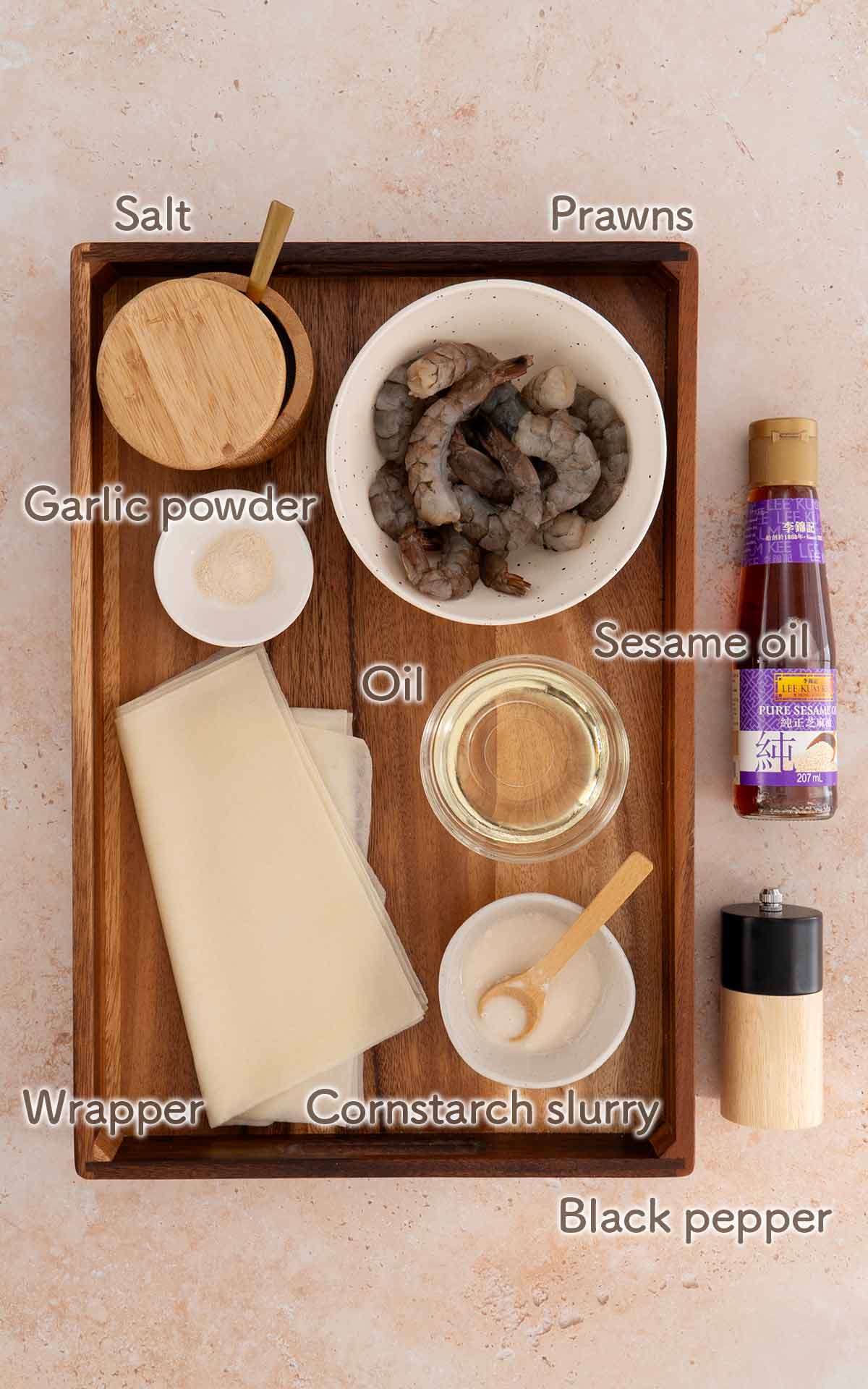 Labelled ingredients of making firecracker shrimp displayed on the white table. 