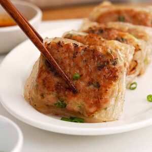 An image of fried crispy rice paper dumplings in a white plate.