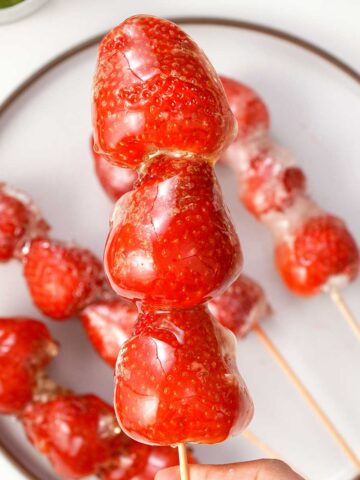 A picture of glossy sugar syrup coated strawberry tanghulu.