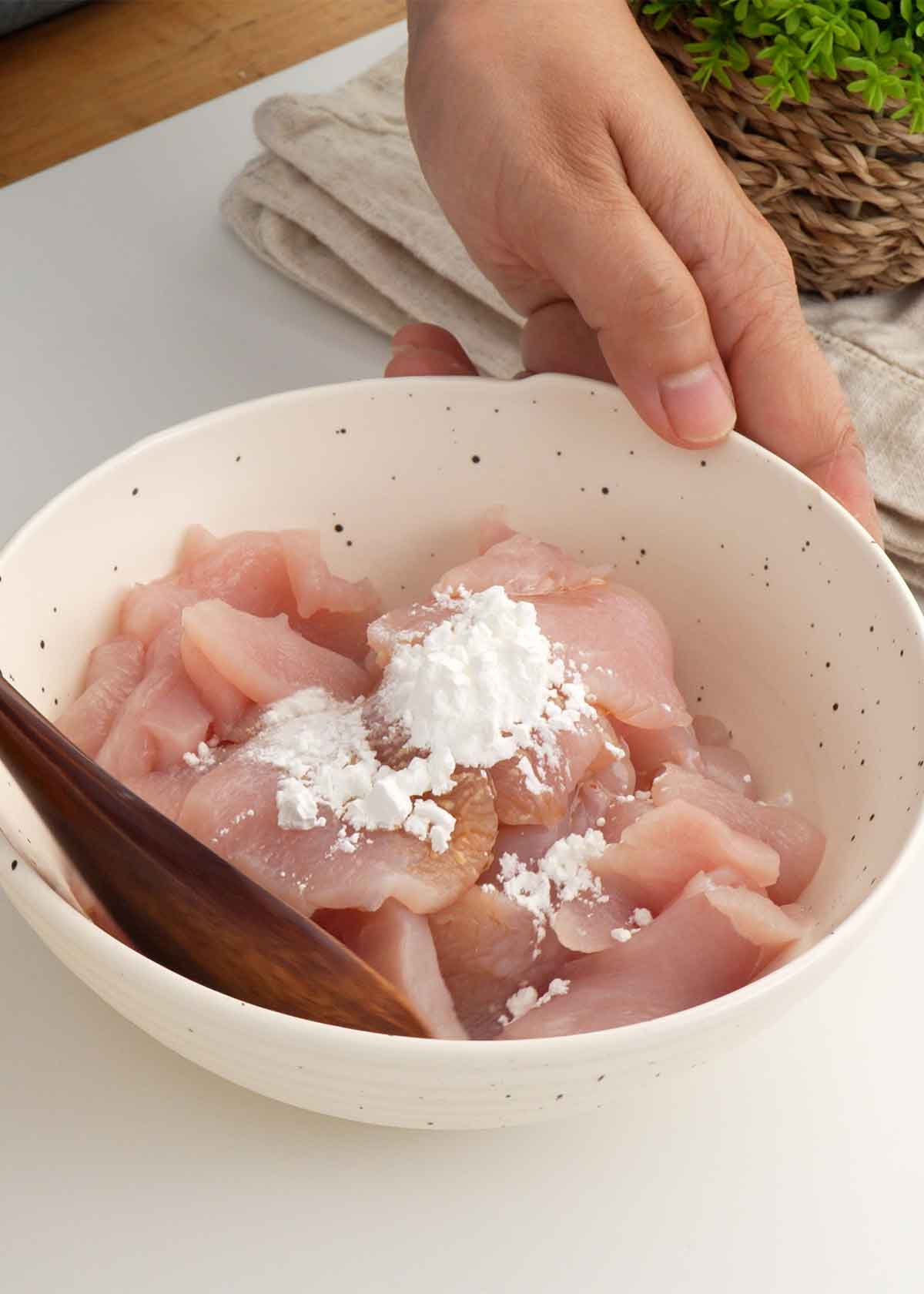 An image showing how to prepare chicken marinade for stir fry. 