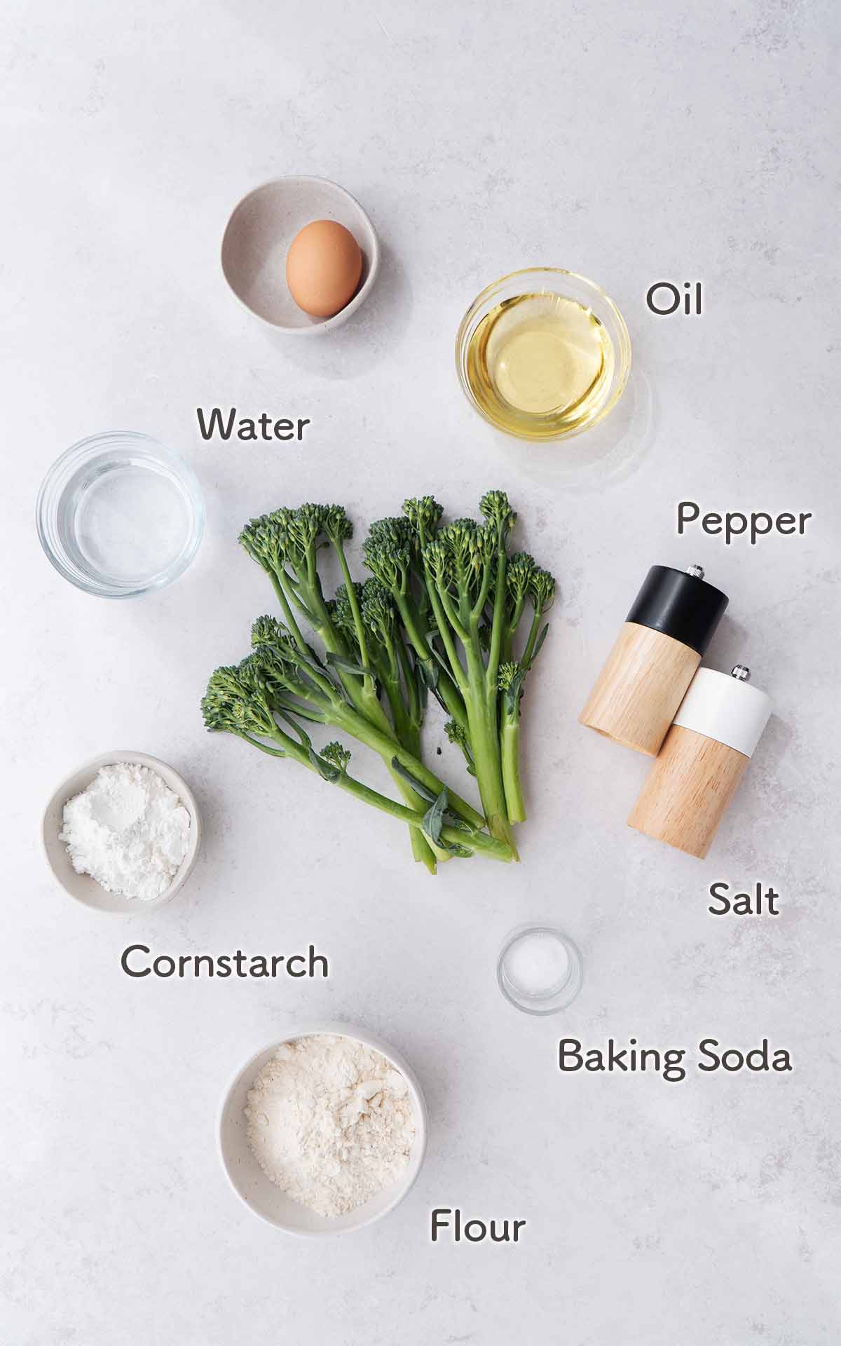 An image of tempura broccoli ingredients displayed on the white table.