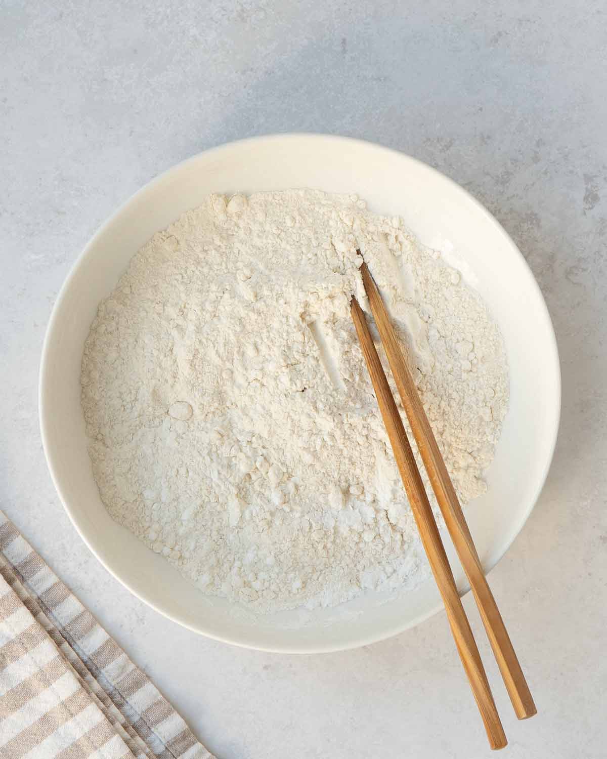 A white bowl containing tempura flour mixture.