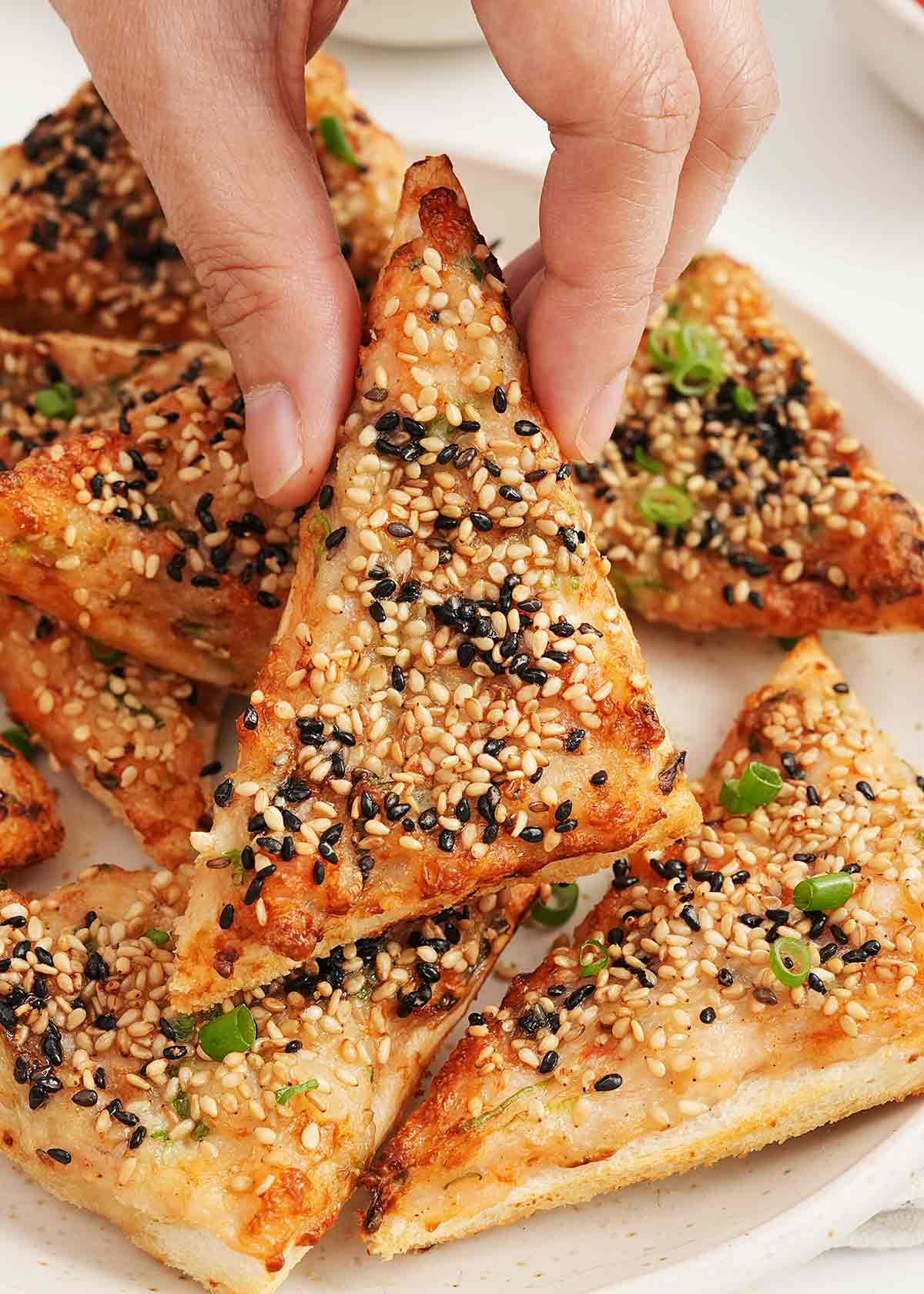 Crispy fried sesame prawn toast with white and black sesame seeds.