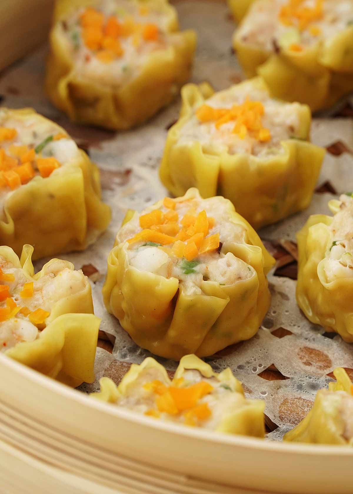 Siu mai dumplings displayed on the wooden steamer.