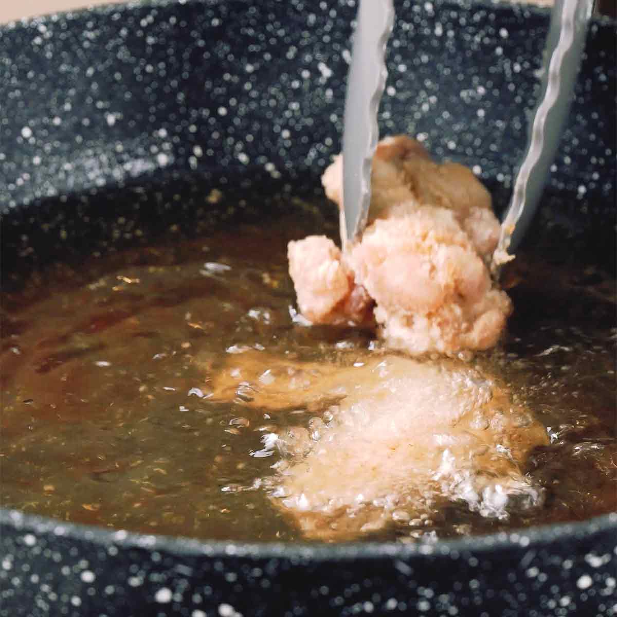 A picture showing frying the chicken wings second time in hot oil.
