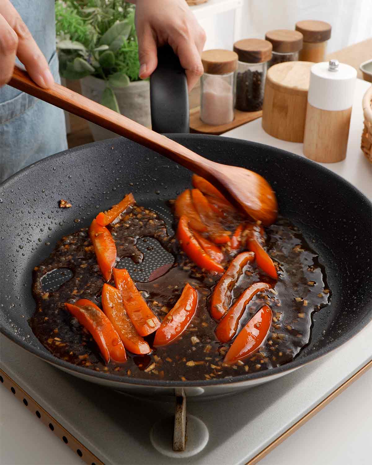 Cooking peppers and garlic with the stir fry sauce.