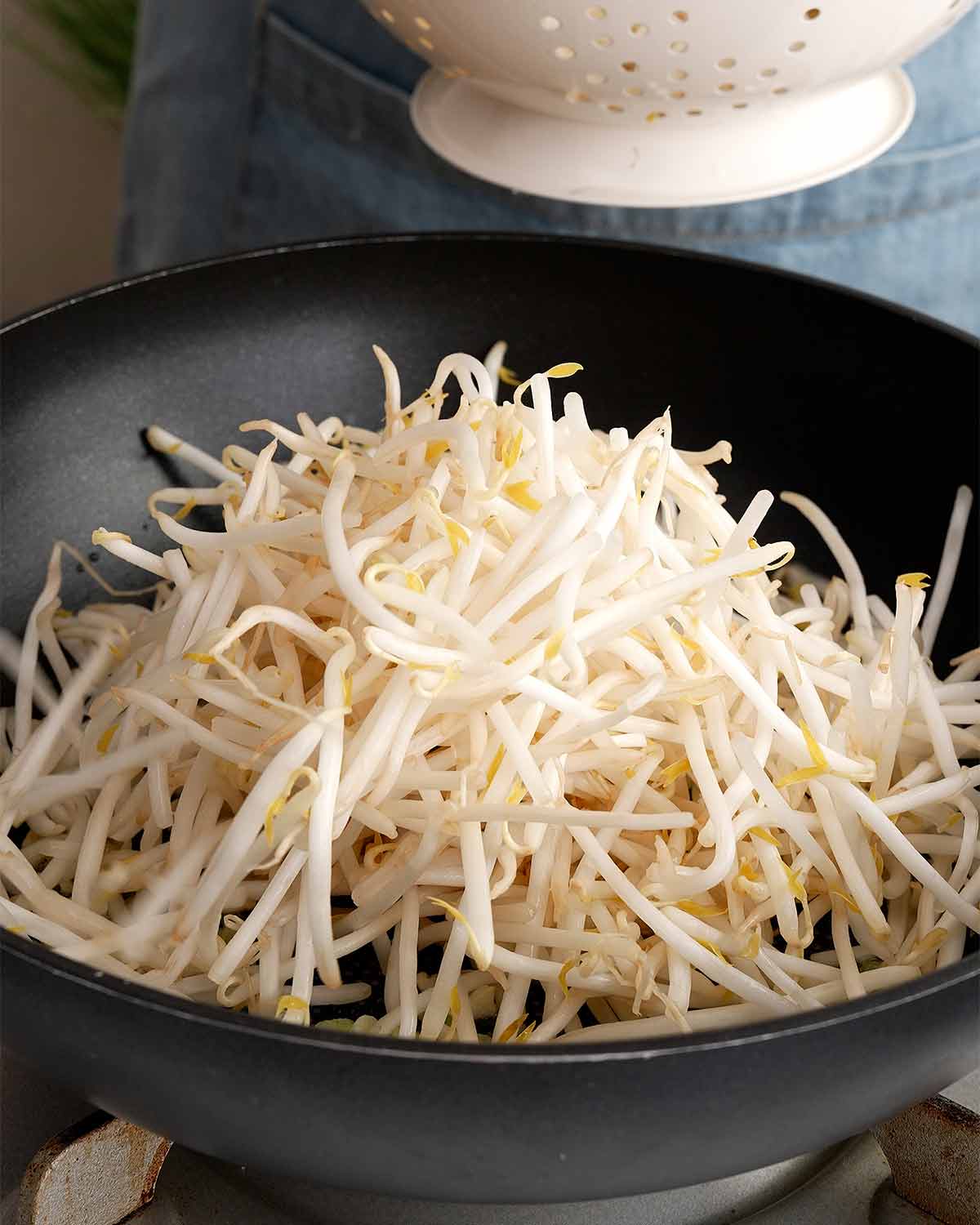 An image showing, bean sprouts in a large wok.
