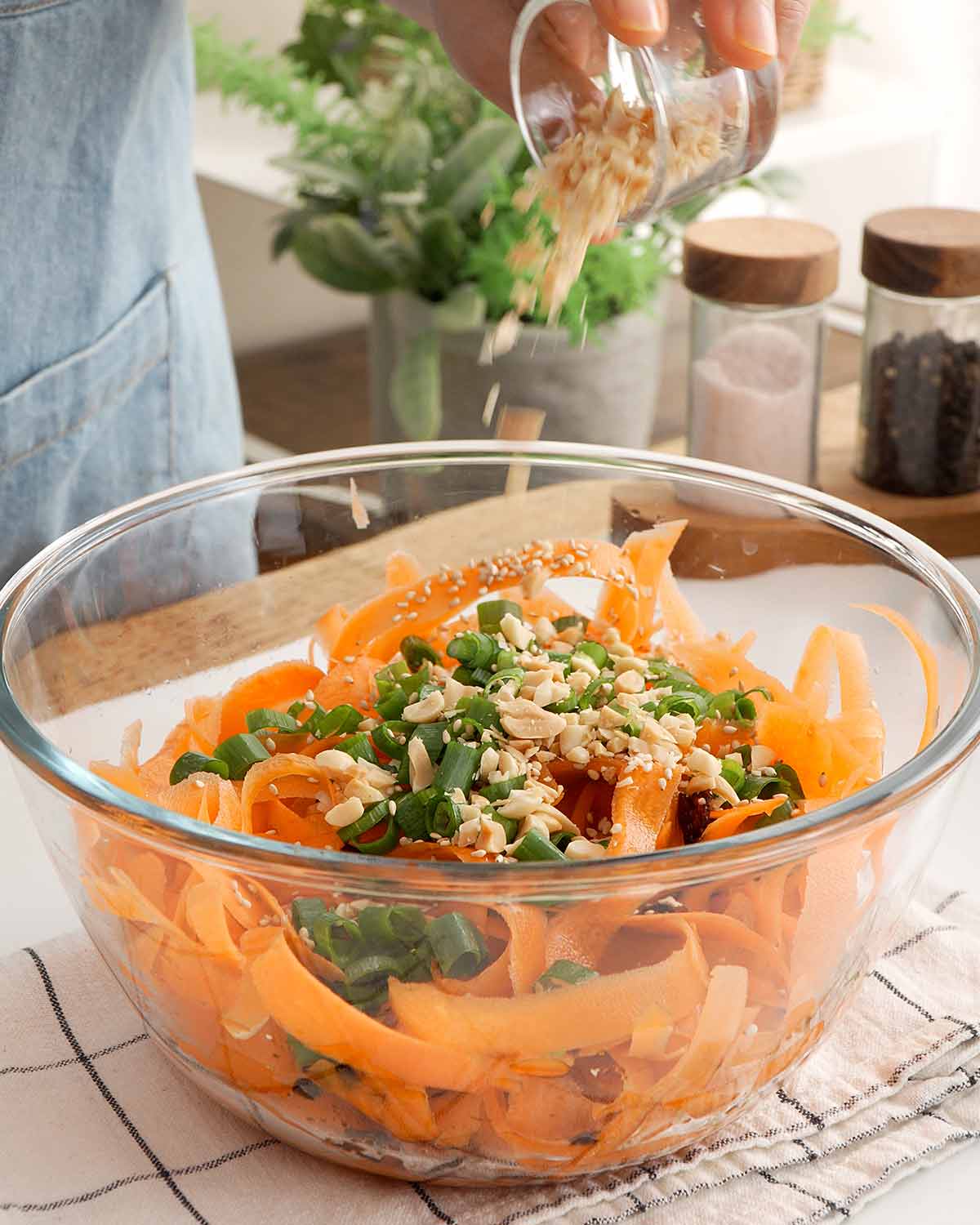 An image showing combining the salad seasonings and toppings in a large mixing bowl.
